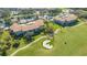 An aerial view of a residential complex, tennis court, pool, water feature, and golf course at 9620 Club South Cir # 5304, Sarasota, FL 34238