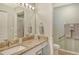 Well-lit bathroom with granite countertops, a large mirror, and a walk-in shower at 9620 Club South Cir # 5304, Sarasota, FL 34238