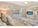 Comfortable bedroom with natural lighting, a ceiling fan, and a dresser with a television at 9620 Club South Cir # 5304, Sarasota, FL 34238