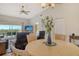 Open concept dining room with vaulted ceilings, views of the golf course, and access to the balcony at 9620 Club South Cir # 5304, Sarasota, FL 34238