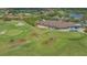 Scenic aerial of golf course, manicured green, sand traps and lush landscaping surround the club house at 9620 Club South Cir # 5304, Sarasota, FL 34238