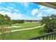 Scenic golf course and lake views from the screened balcony, showcasing manicured greens and surrounding natural beauty at 9620 Club South Cir # 5304, Sarasota, FL 34238