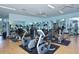 Bright community gym with lots of equipment, wood floors, and ceiling fans at 9620 Club South Cir # 5304, Sarasota, FL 34238