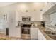 Well-lit kitchen featuring stainless steel appliances, granite countertops, and ample white cabinetry at 9620 Club South Cir # 5304, Sarasota, FL 34238