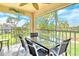 Screened lanai with views of the surrounding greenery, and table and chairs, providing a relaxing atmosphere at 9620 Club South Cir # 5304, Sarasota, FL 34238