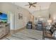 Cozy living room with neutral tones, hard flooring, leather seating, and a view into the dining area at 9620 Club South Cir # 5304, Sarasota, FL 34238