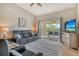 Comfortable living room showcasing balcony views, a sofa, and natural lighting at 9620 Club South Cir # 5304, Sarasota, FL 34238