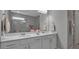 The bathroom has dual sinks, a large mirror, and a beautifully tiled shower at 10414 Spring Tide Way, Parrish, FL 34219