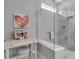 The bathroom includes a modern glass shower and stylish decor at 10414 Spring Tide Way, Parrish, FL 34219