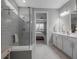 The bathroom boasts a glass-enclosed shower and a dual sink vanity at 10414 Spring Tide Way, Parrish, FL 34219