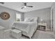 A bedroom featuring a white bedspread, plush carpet, neutral paint, and views of the outdoors at 10414 Spring Tide Way, Parrish, FL 34219