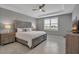 This bedroom has stylish decor, a ceiling fan, and tile flooring for comfort and elegance at 10414 Spring Tide Way, Parrish, FL 34219
