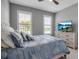 Comfortable bedroom with neutral walls, shuttered windows and coastal themed bedding at 10414 Spring Tide Way, Parrish, FL 34219