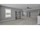 A bonus room with plush carpet, neutral paint, open shelving, and lots of windows for natural light at 10414 Spring Tide Way, Parrish, FL 34219