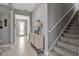 Hallway with stairs to the upper level and stylish console table at 10414 Spring Tide Way, Parrish, FL 34219