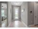 Bright foyer with tile flooring and a glass-paneled front door, creating an inviting entrance at 10414 Spring Tide Way, Parrish, FL 34219