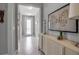 Inviting foyer with neutral tones, stylish console table, and elegant butterfly artwork at 10414 Spring Tide Way, Parrish, FL 34219