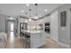 Modern kitchen with an island, stainless steel appliances, and stylish lighting fixtures creating a sleek design at 10414 Spring Tide Way, Parrish, FL 34219