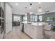 Open-concept kitchen featuring a large island, modern appliances, and seamless flow to living and dining areas at 10414 Spring Tide Way, Parrish, FL 34219