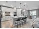 Bright, open kitchen featuring a center island, bar stools, and modern appliances leading to a dining area at 10414 Spring Tide Way, Parrish, FL 34219