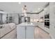 Modern kitchen with a central island, pendant lighting, and stainless steel appliances for a gourmet cooking experience at 10414 Spring Tide Way, Parrish, FL 34219