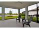 Relaxing screened lanai with comfortable seating, overlooking a serene pond and lush landscaping at 10414 Spring Tide Way, Parrish, FL 34219