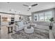 Spacious open-concept living area flowing from a modern kitchen, featuring stylish decor and bright lighting at 10414 Spring Tide Way, Parrish, FL 34219