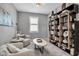 Cozy living room with custom bookcase, soft chairs, and neutral decor for a comfortable atmosphere at 10414 Spring Tide Way, Parrish, FL 34219