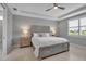 This main bedroom features a ceiling fan, tile floors, and natural light, creating a relaxing retreat at 10414 Spring Tide Way, Parrish, FL 34219