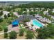 Aerial view showcasing a community pool, clubhouse, playground, and lush landscaping at 11342 77Th E St, Parrish, FL 34219
