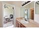 Bathroom featuring a sink with wood cabinets and a view of the outdoor patio and pool at 11342 77Th E St, Parrish, FL 34219