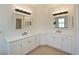 Bathroom featuring dual vanities with white cabinets, quartz countertops, and modern fixtures at 11342 77Th E St, Parrish, FL 34219