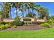 Community entrance sign with lush landscaping and decorative stone pillars at 11342 77Th E St, Parrish, FL 34219