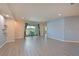 Bright living room featuring wood floors and sliding doors leading to a screened patio with lake views at 11342 77Th E St, Parrish, FL 34219