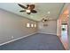 Bright, spacious living room with carpet, ceiling fan and view of the backyard at 11342 77Th E St, Parrish, FL 34219