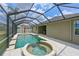 Outdoor pool and spa area with screened-in enclosure at 11342 77Th E St, Parrish, FL 34219