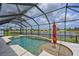 Screened-in pool features a spa and water feature, with a view of the serene lake at 11342 77Th E St, Parrish, FL 34219