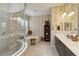 Bathroom with a soaking tub, large shower, and patterned wallpaper at 12240 Thornhill Ct, Lakewood Ranch, FL 34202