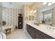 Bathroom featuring floral wallpaper, a soaking tub, and an extra long vanity with double sinks at 12240 Thornhill Ct, Lakewood Ranch, FL 34202