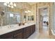 Bathroom featuring double sinks, dark wood cabinets, and shower at 12240 Thornhill Ct, Lakewood Ranch, FL 34202