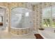 Bathroom featuring an enclosed glass shower, a window with blinds, and floral wallpaper at 12240 Thornhill Ct, Lakewood Ranch, FL 34202