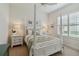 Cozy bedroom with a canopy bed, soft colors, and shuttered windows for natural light at 12240 Thornhill Ct, Lakewood Ranch, FL 34202