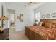 Bedroom with decorative pillows, wicker bed frame, plantation shutters, and neutral carpet at 12240 Thornhill Ct, Lakewood Ranch, FL 34202