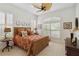 Bedroom with wicker bed frame, plantation shutters, ceiling fan, and neutral carpet at 12240 Thornhill Ct, Lakewood Ranch, FL 34202