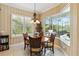 Inviting breakfast nook with a view of the lanai, pool, and outdoor grill at 12240 Thornhill Ct, Lakewood Ranch, FL 34202