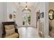 Bright foyer with soaring ceilings, tiled floor, and double doors leading to the outdoors at 12240 Thornhill Ct, Lakewood Ranch, FL 34202