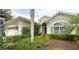 Well maintained home with beautiful landscaping and lush tropical plants in the front yard at 12240 Thornhill Ct, Lakewood Ranch, FL 34202