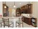 Well-appointed kitchen with granite countertops, dark wood cabinetry and barstool seating at 12240 Thornhill Ct, Lakewood Ranch, FL 34202