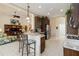 Open concept kitchen with counter seating overlooking the living room in a well lit space at 12240 Thornhill Ct, Lakewood Ranch, FL 34202