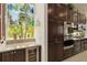 Gourmet kitchen featuring granite countertops, modern appliances, and a wine refrigerator at 12240 Thornhill Ct, Lakewood Ranch, FL 34202